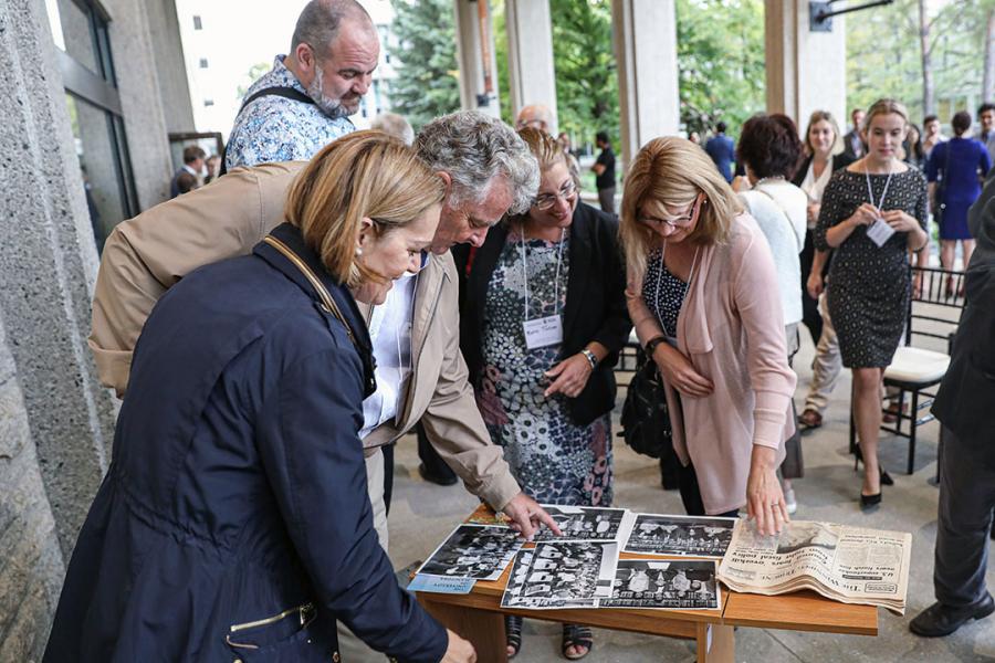 Time capsule homecoming alumni looking at contents