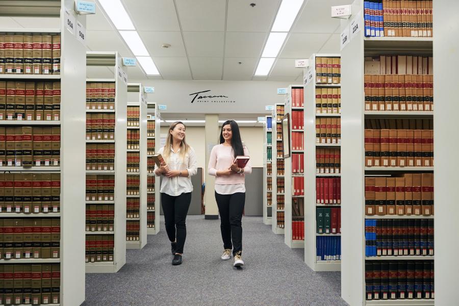 Two students walking through the E.K. Williams Law Library