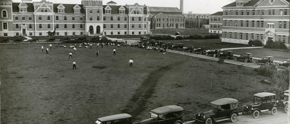 Image of early 20th century University of Manitoba campus and students playing baseball