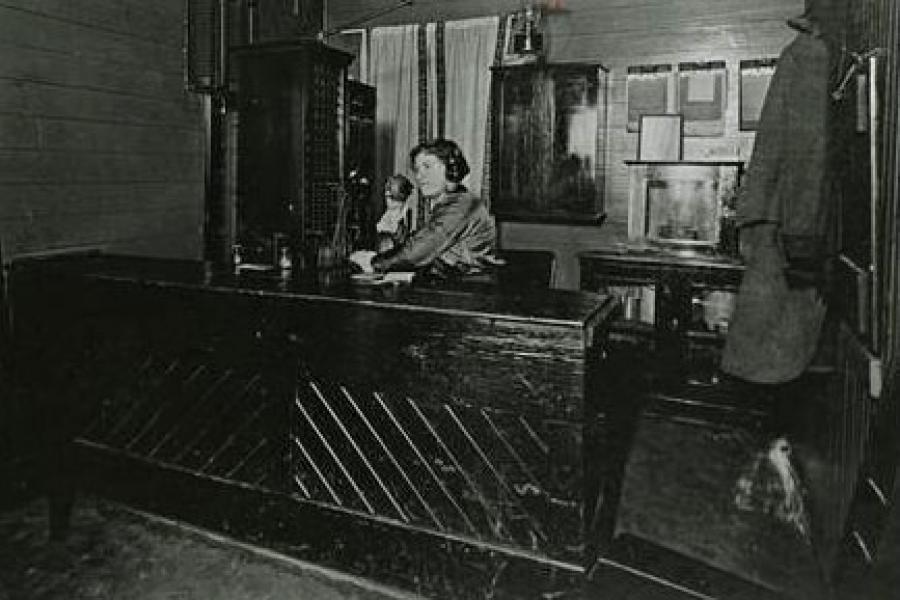 A telephone operator at her desk, dated from early 1900s.