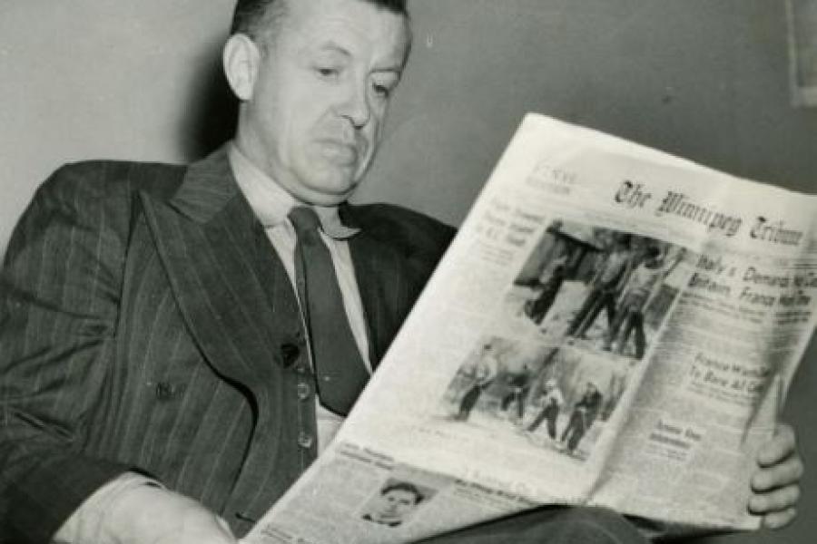A man in a 1930s suit is reading the Tribune. We see the front page of the Tribune. The photo is dated 1939.