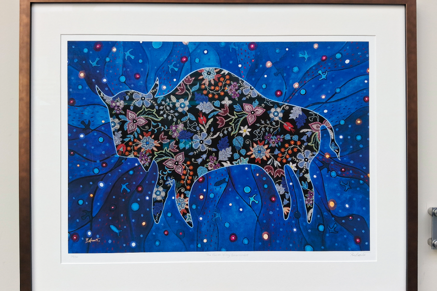 Indigenous art of a Bison with Metis-style beadwork patterns against blue background