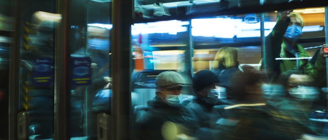 peoplefrom different cultural backgrounds on a bus at night time