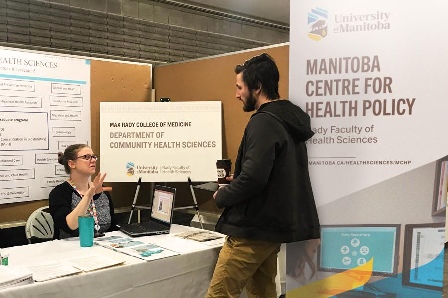 Student talking to prospective student at a student fair 