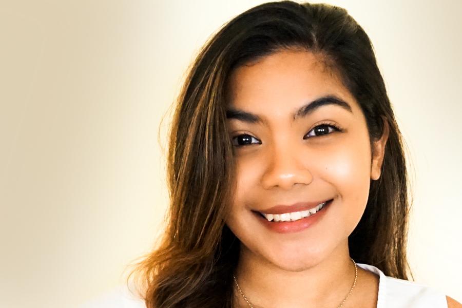 Hera Casidsid on a white background smiling at the camera. 