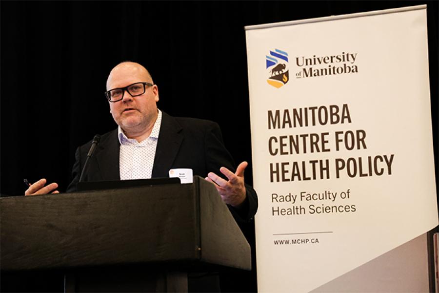 Deputy Minister of Health, Scott Sinclair giving speach at podium