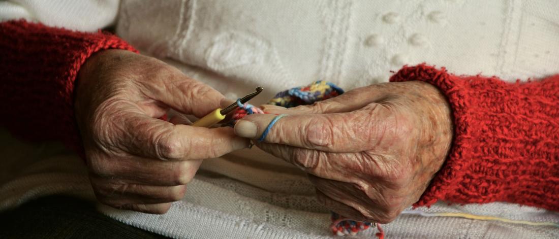 Close up of a woman's hands knitting.