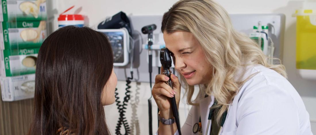 Physician examines a woman's eye.
