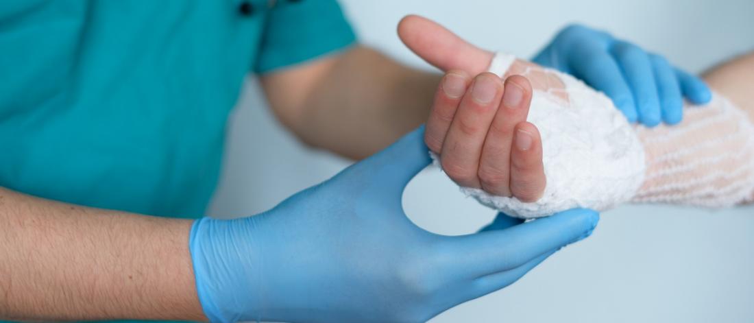 Surgeon bandaging a hand.