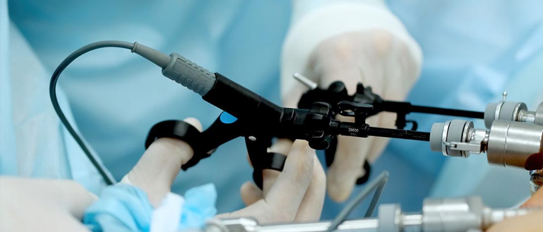 Hands of surgeons performing laparoscopic surgery.