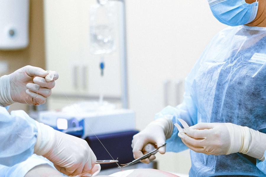 Surgeon doing a suture.