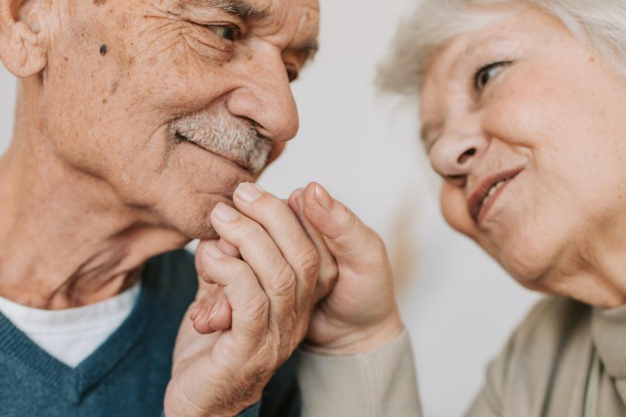 Elderly couple holding hands.