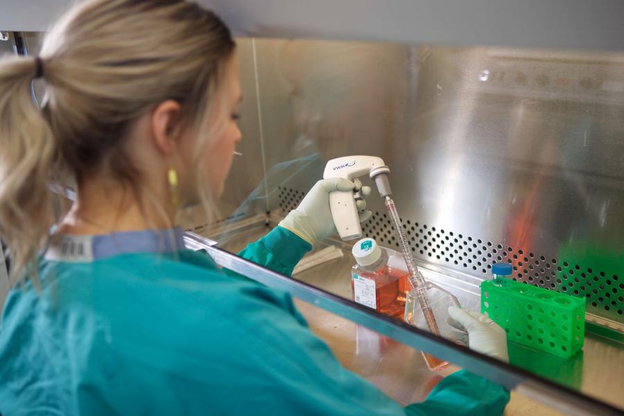 Researcher working with a test tube.