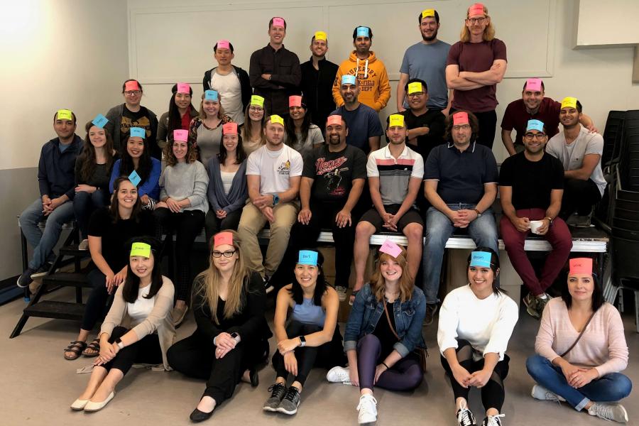 Residents at a retreat with paper stickers on their foreheads.