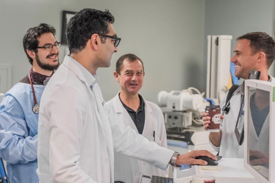 A group of scientists review a computer screen.