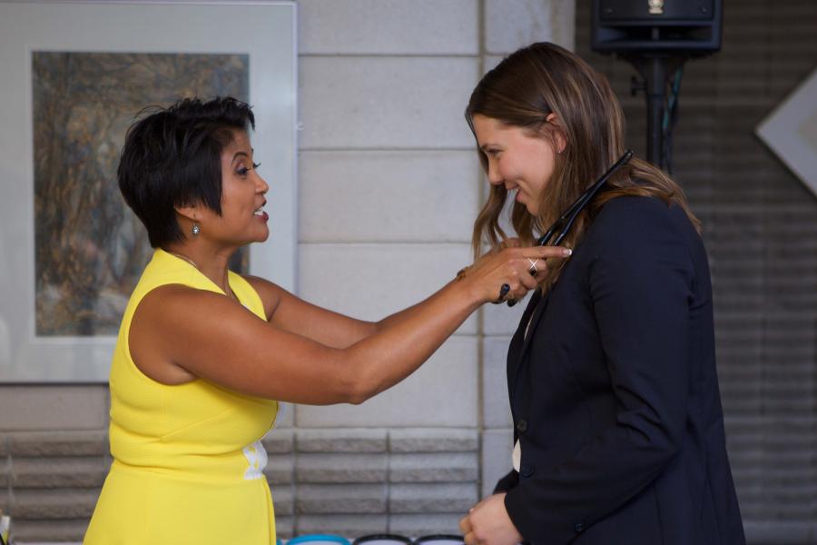 A physician assistant student is inaugurated into the program with a stethoscope placed around their neck 