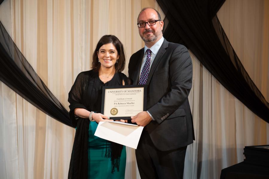 Dr. Jose Francois (right) on stage receiving an award