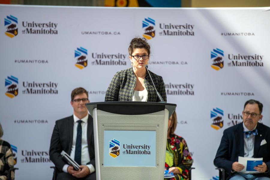 Rebecca Mueller speaks at a podium during an event