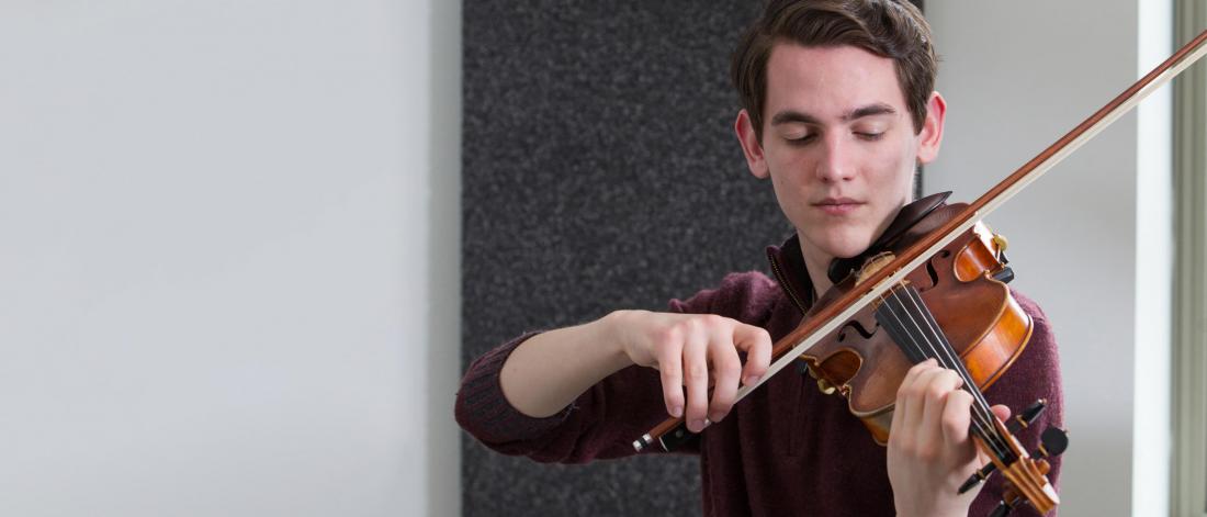 A student practicing the violin.