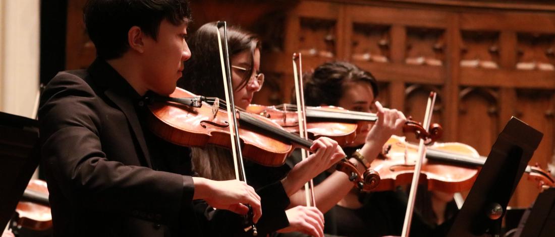 Violinists perform with the University of Manitoba Symphony Orchestra