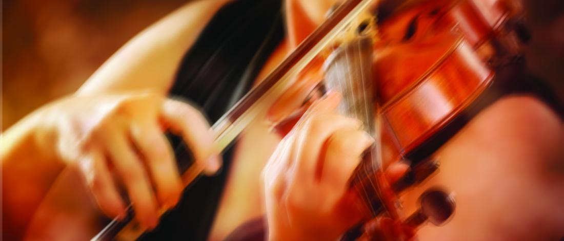 a blurred in motion image of someone playing violin
