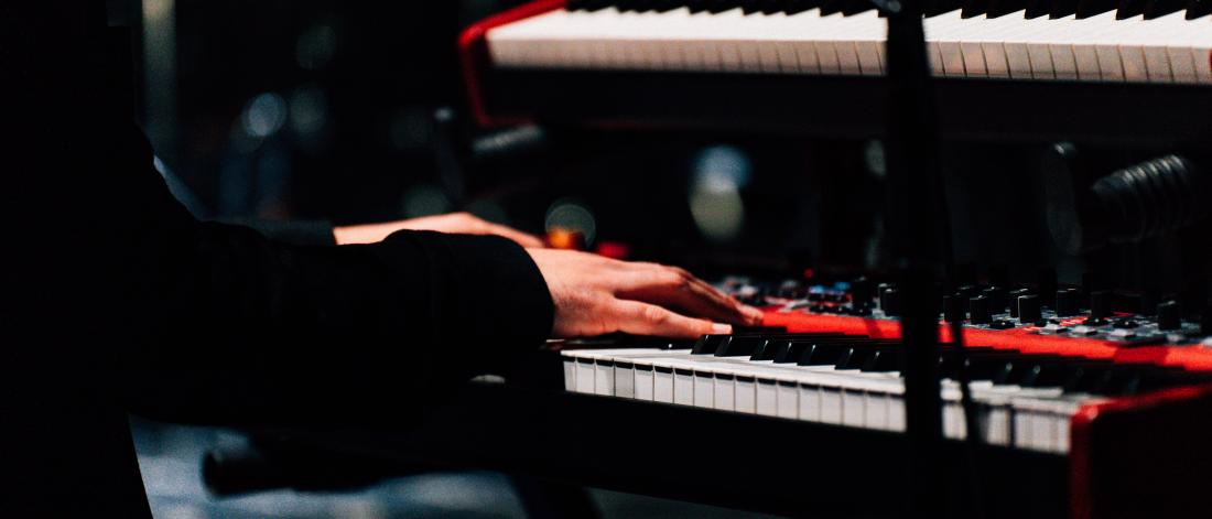 hands playing piano in the concert hall