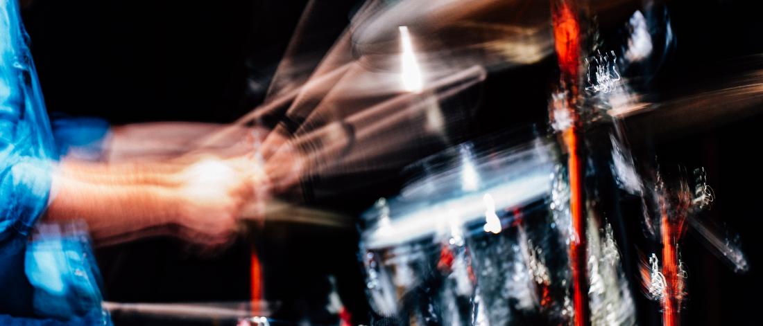 Blurred image of someone drumming