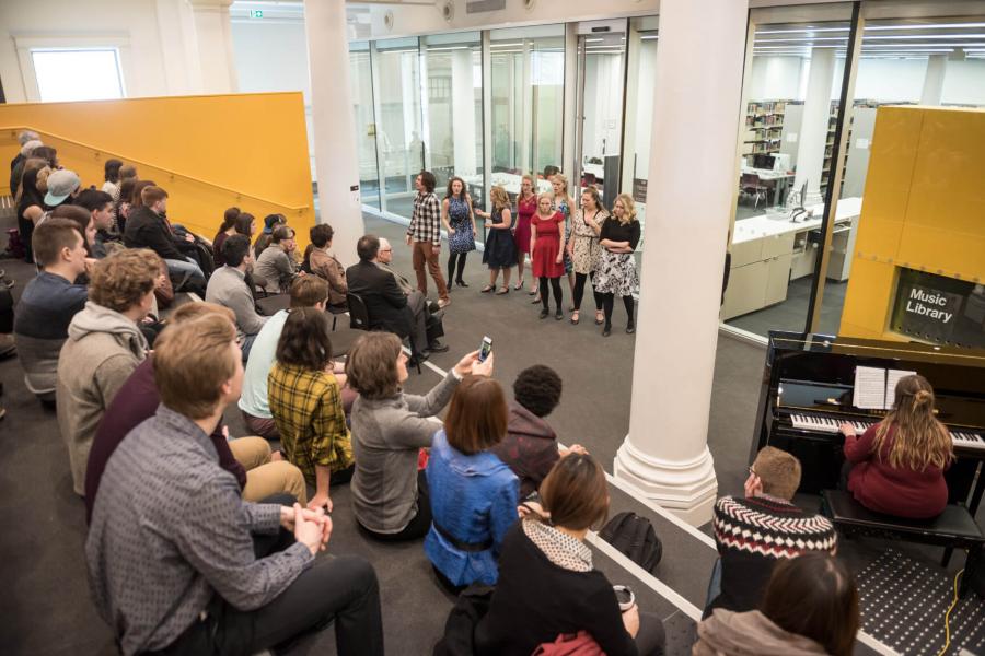 Desautels students perform for an audience in the library concourse.