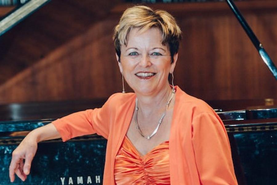 Collaborative Piano Professor Judy Kehler Siebert sitting at piano