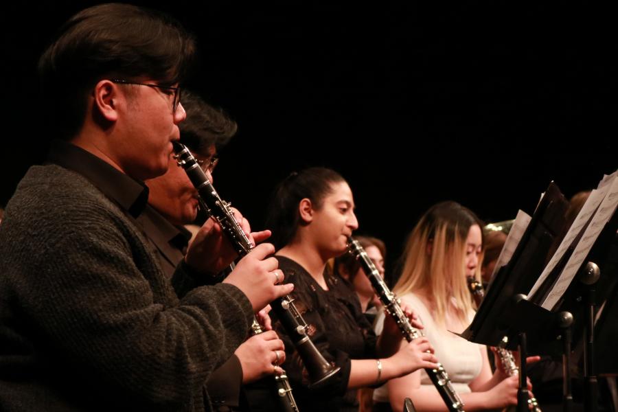 Music students playing clarinet in concert