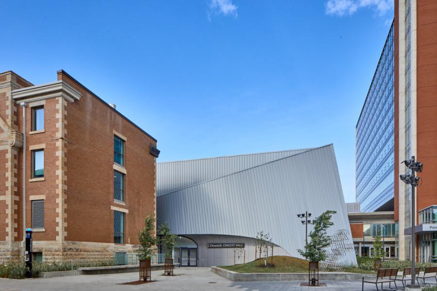 Landscape shot of the Desautels Concert Hall with Tache Hall on the left and the Ai Wei Wei Sculpture on the right