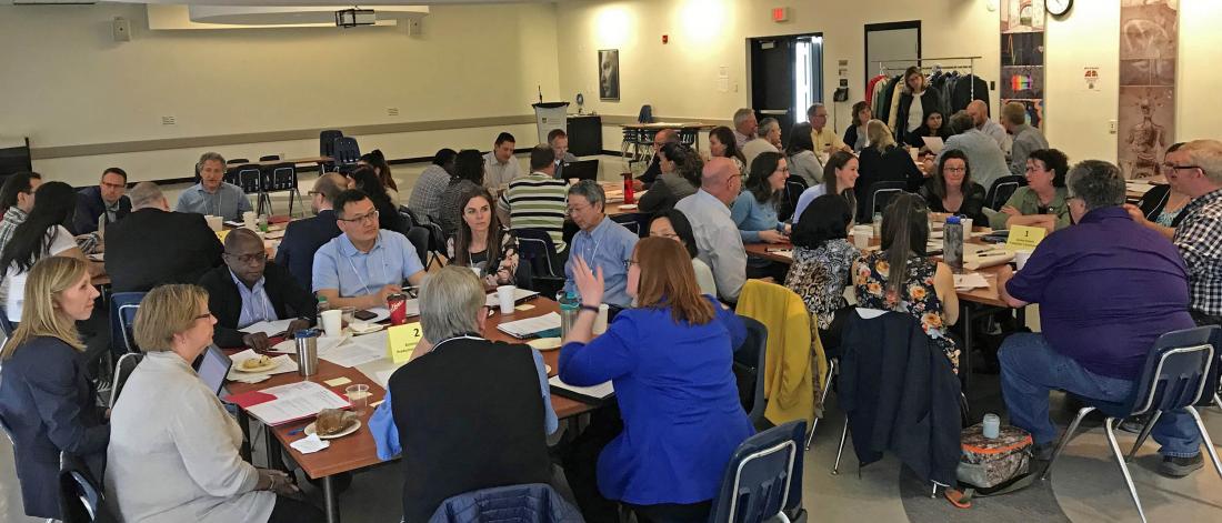 Partners hero image, tables of people chatting