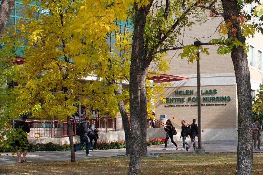 Students walking to and from class outside of the Helen Glass Centre for Nursing on a fall day.