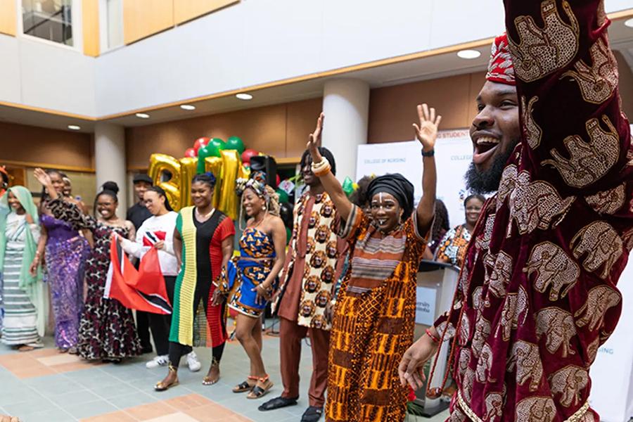 A group of people celebrate Black History month at a kick off event.