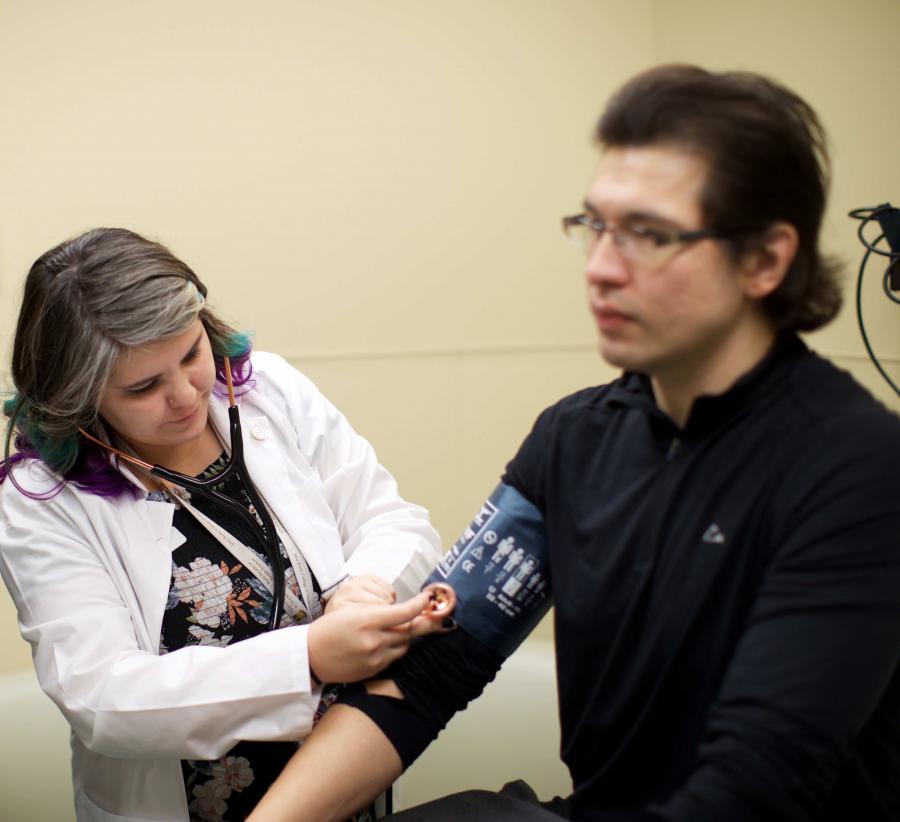 An Indigenous medical student checks a patients blood pressure.