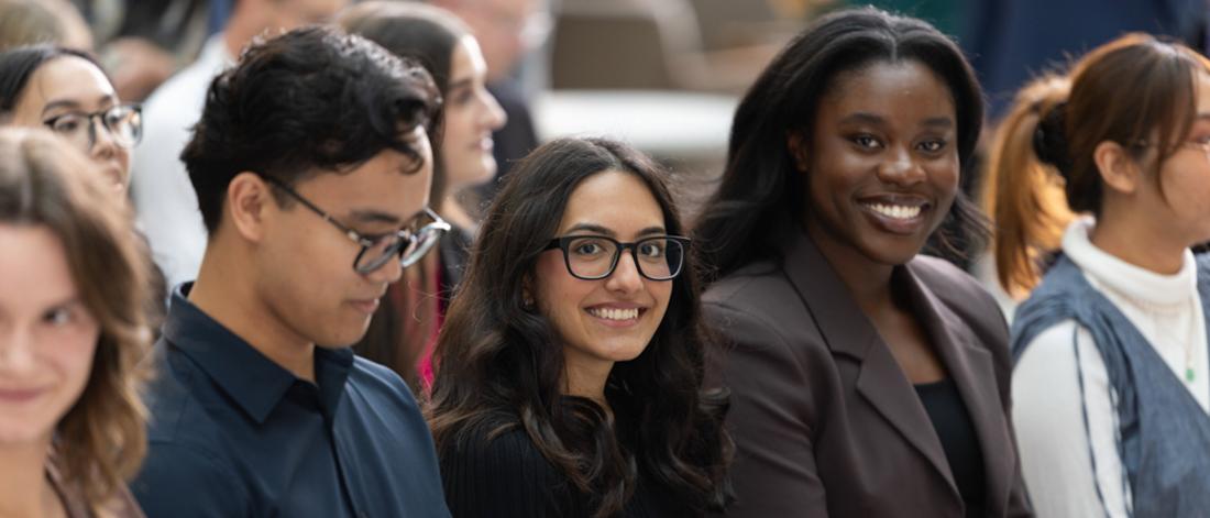 Several pharmacy students sit together and talk in the student lounge.