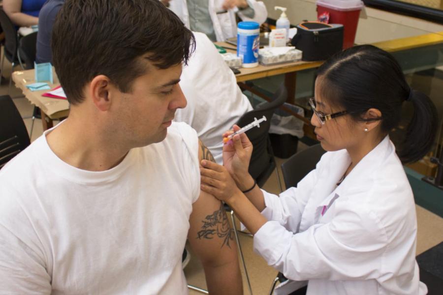 A community member receives a flu shot during a pharmacy student flu clinic. 