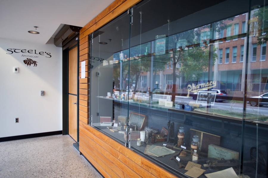 An exterior view of Steele's Apothecary with a large display case. 