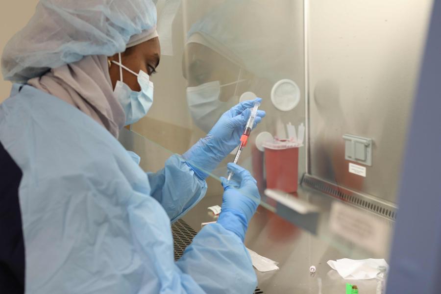 a pharmacy student conducting research in a lab.