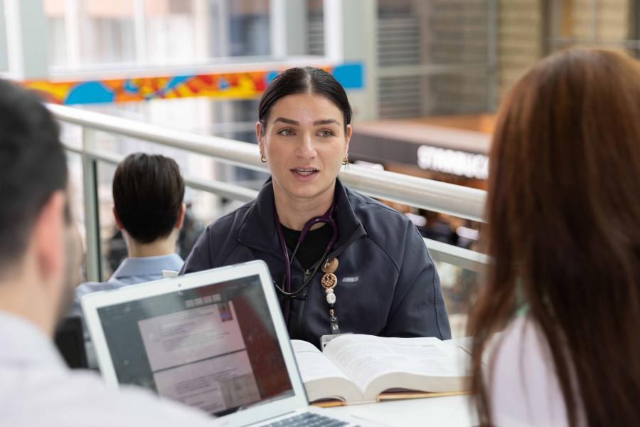 Students seated at a table, having a discussion.