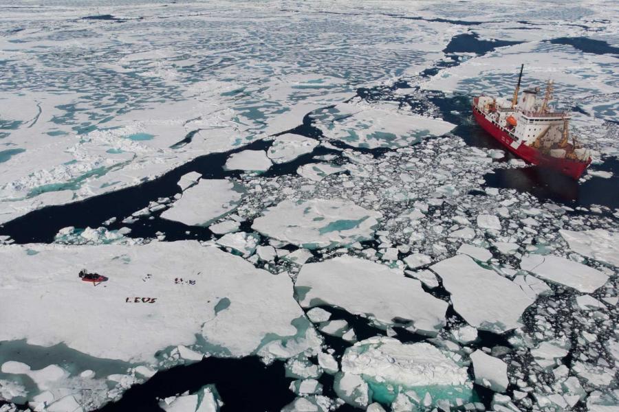 An icebreaker ship moves through the Arctic ice.