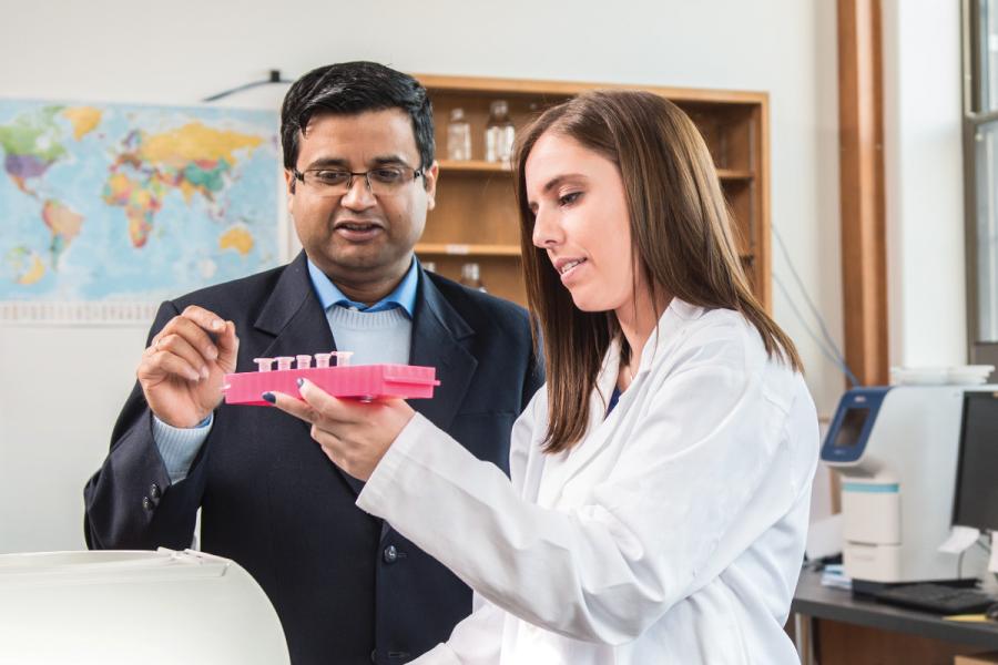 Ayush Kumar and Taylor Morrisseau working together in a laboratory