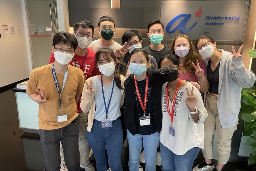 Students wearing face masks smiling at the camera.