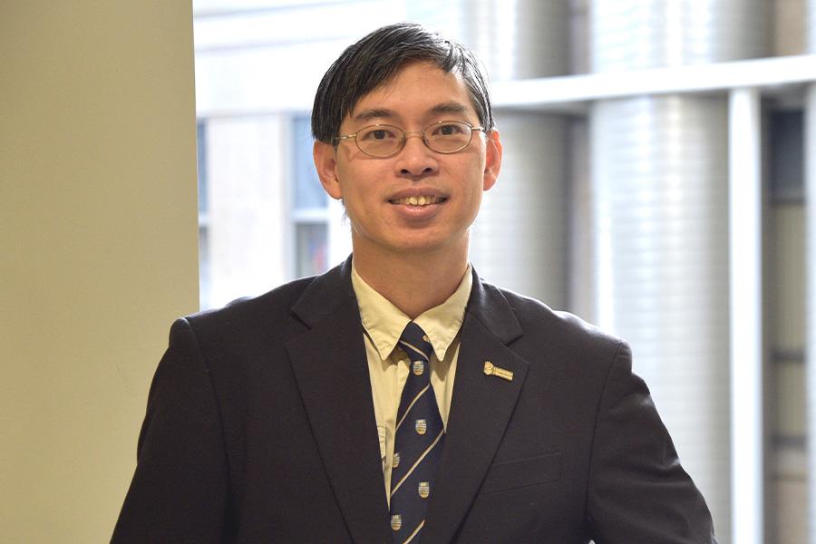Carson Leung wearing glasses and smiling at the camera.