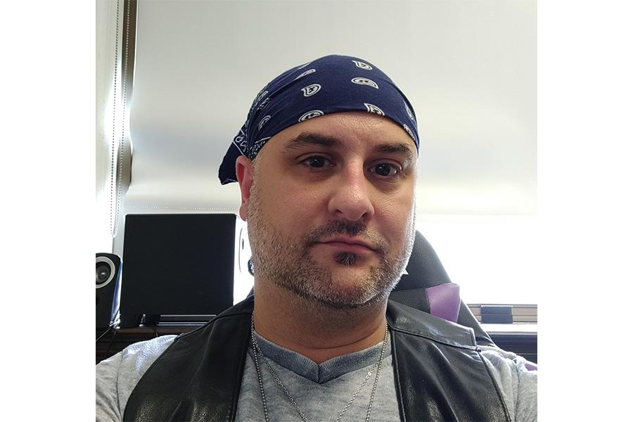 Damien Michael River wearing a bandana and looking at the camera.