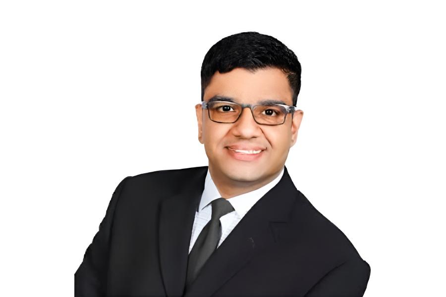 Sumeet Kalia wearing an eyeglass and smiling at the camera.