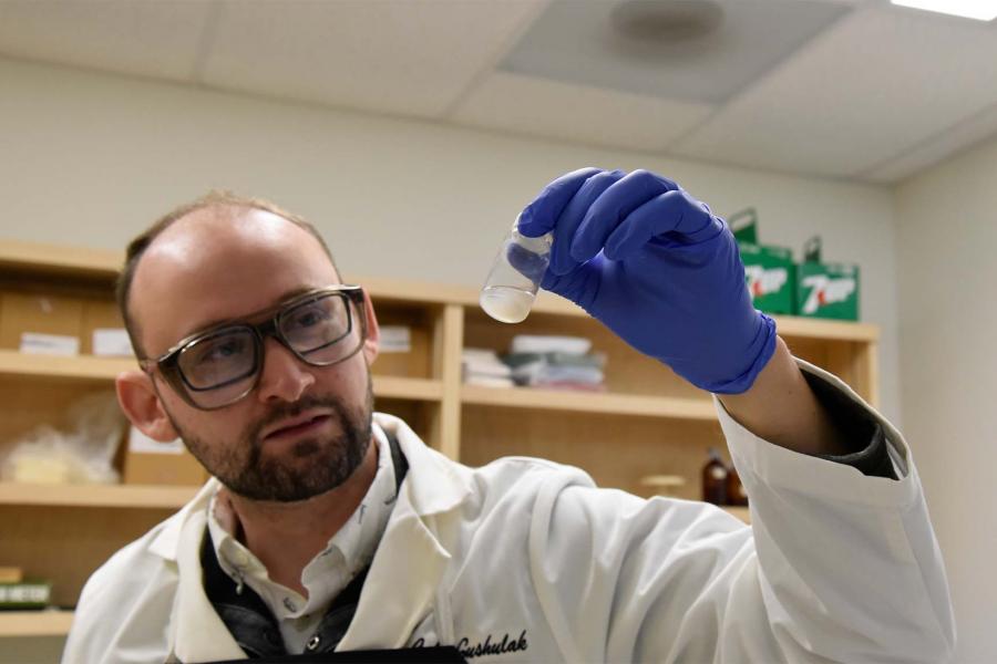 Cale Gushulak examining a specimen.