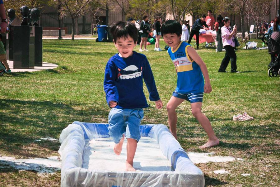 Two kids having fun at the oobleck run and smiling.