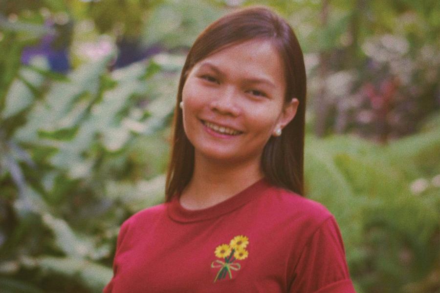 Hermie Monterde wearing a red shirt and smiling at the camera.