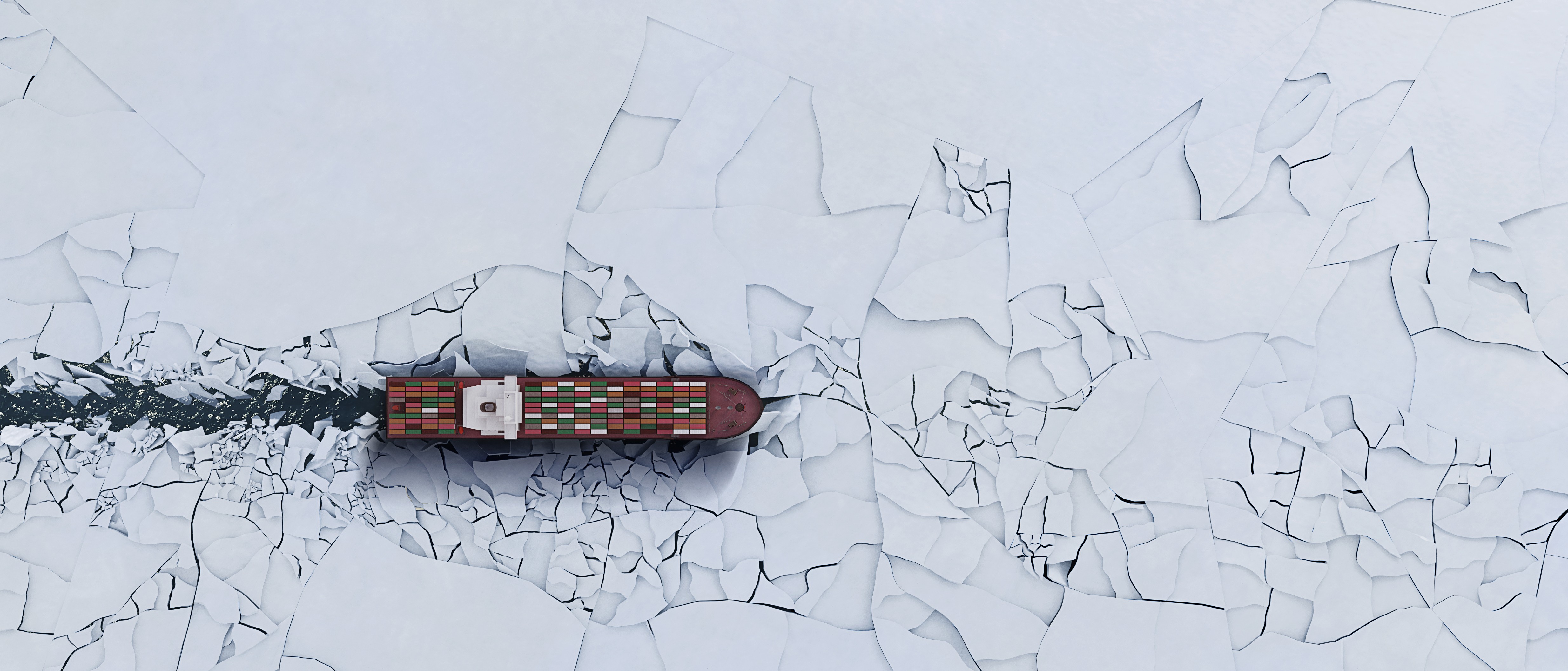 a ship sails through ice in the Arctic waters.